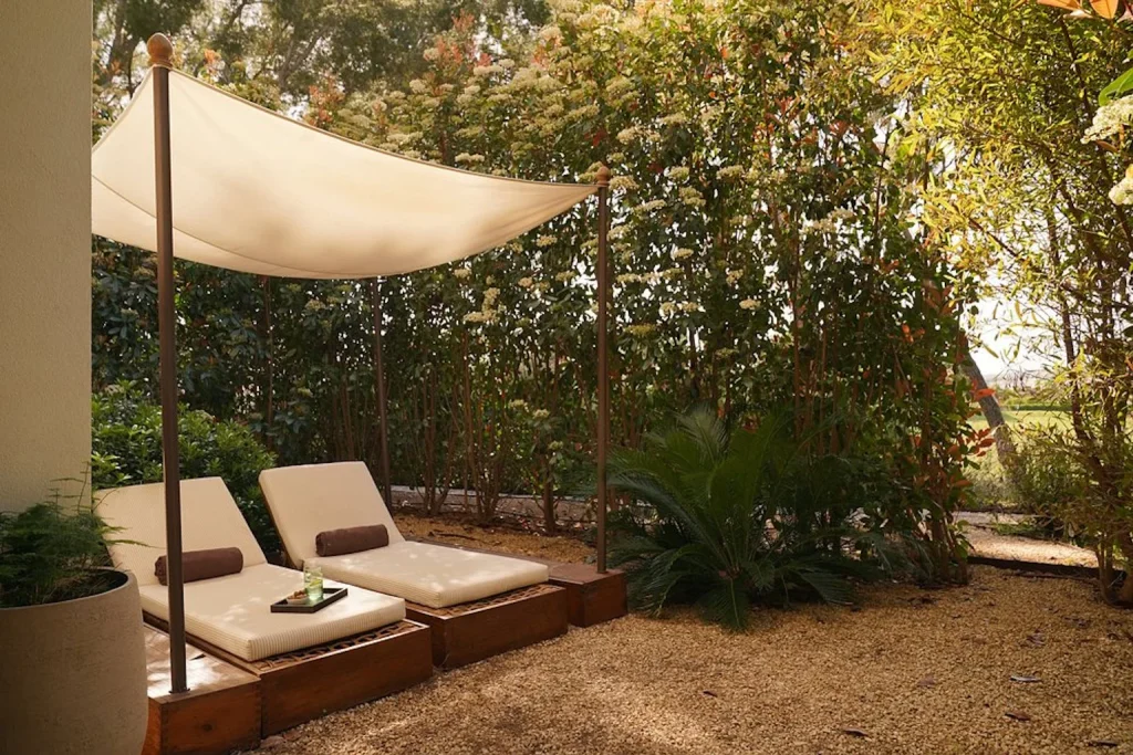 Private garden with sun loungers at Kimpton Aysla Mallorca in Santa Ponsa, Mallorca