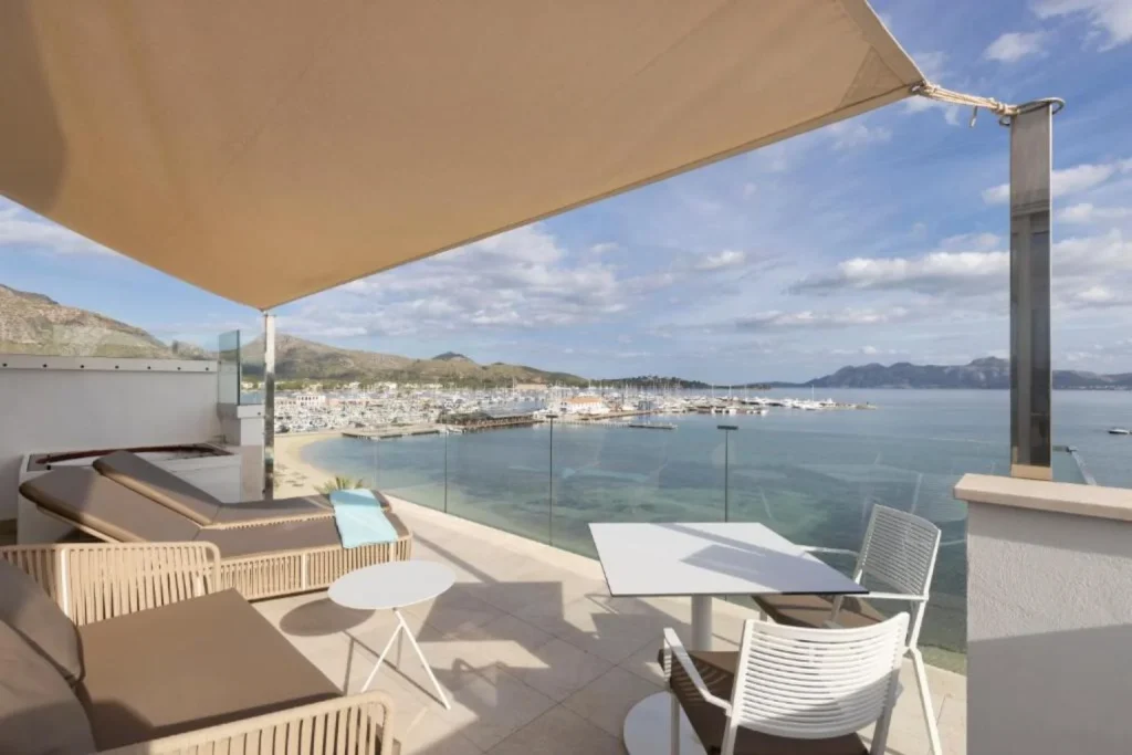 Private seafront terrace with marina and bay views at La Goleta Hotel de Mar in Port de Pollença.