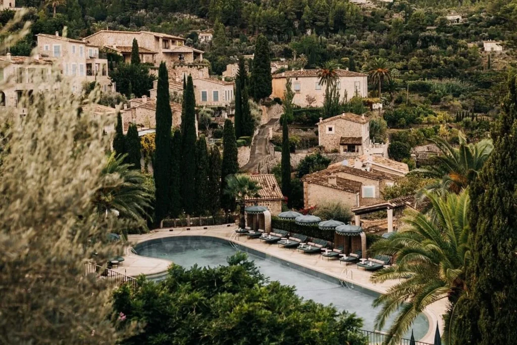 Outdoor pool overlooking the village of Deià and the Tramuntana mountains at La Residencia, A Belmond Hotel, Mallorca.