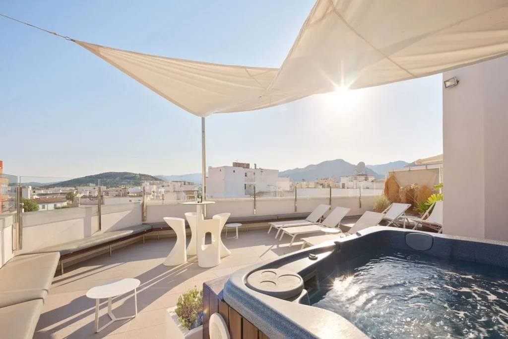 Rooftop terrace with a hot tub, sun loungers, and mountain views at Mar Calma Hotel in Port de Pollença Centre.