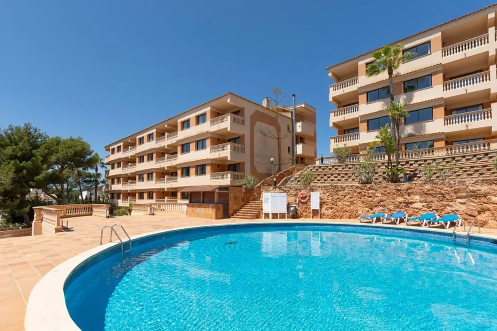 Large outdoor swimming pool in front of the hotel building at Mar Hotels Paguera & Spa in Peguera, Majorca.