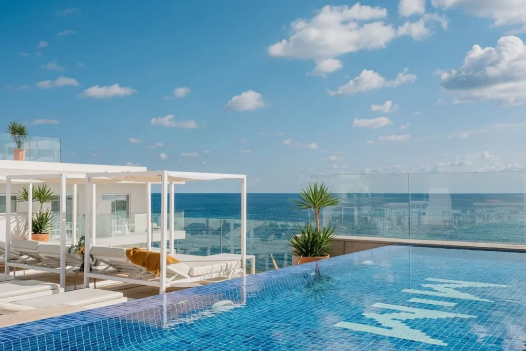 Rooftop infinity pool with sea view at MiM Mallorca Meliá Collection in Sa Coma, Mallorca