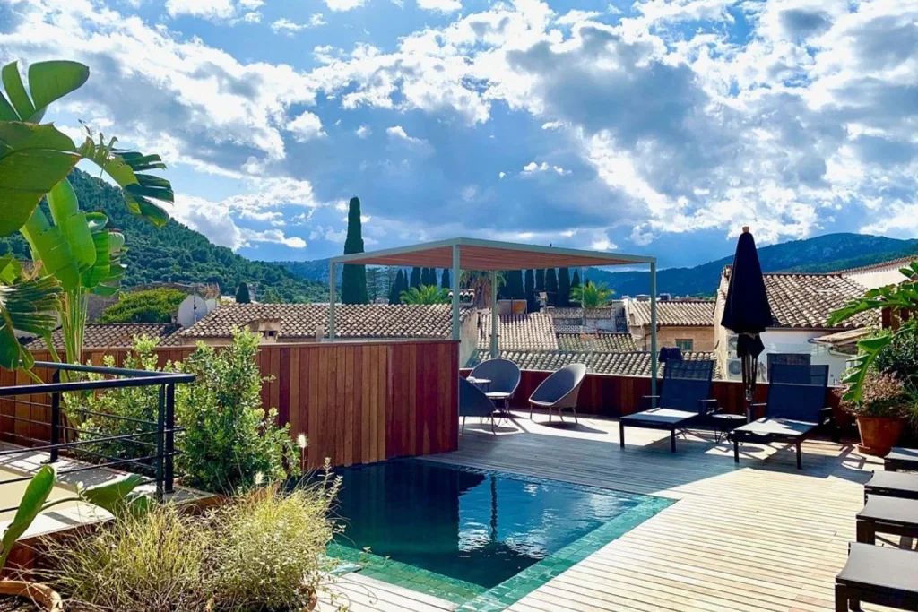Rooftop plunge pool and sun terrace overlooking the rooftops of Pollença Town at Mon Boutique Hotel.