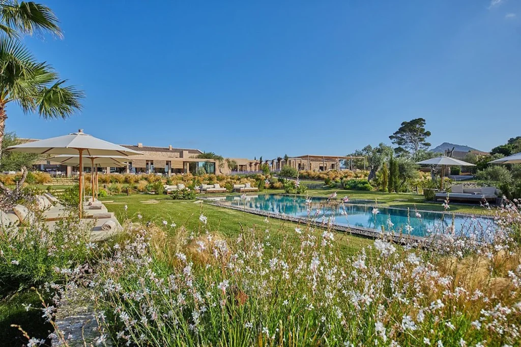 Landscaped garden pool surrounded by Mediterranean greenery at Pleta de Mar in Canyamel, Mallorca.