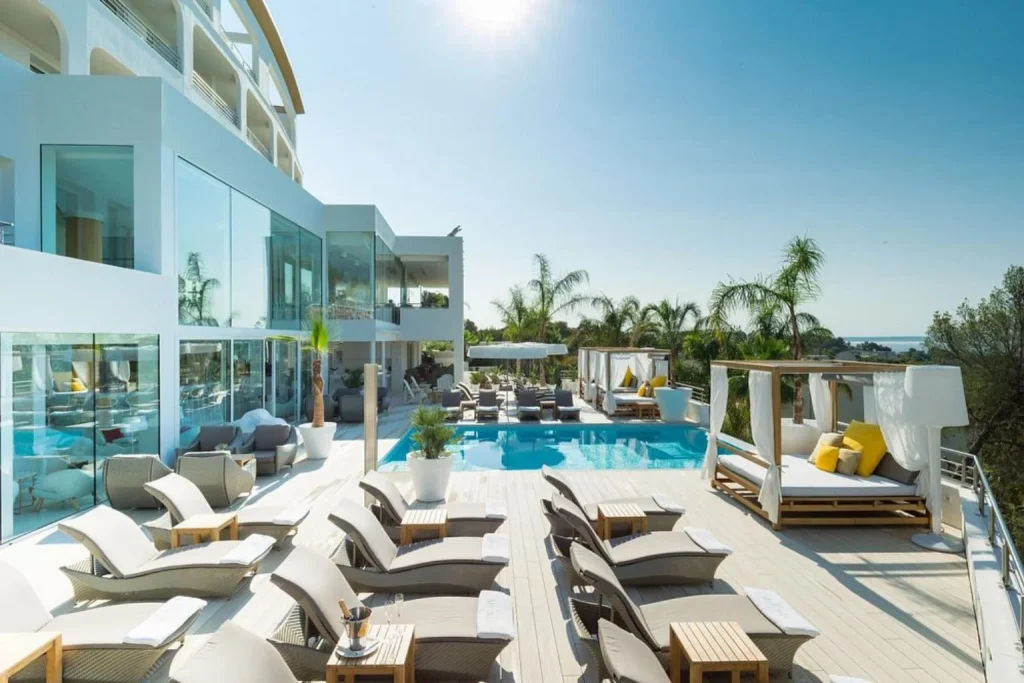 Modern pool deck with luxury cabanas, sun loungers, and stylish outdoor spaces at Portals Hills Boutique Hotel in Mallorca, Spain.