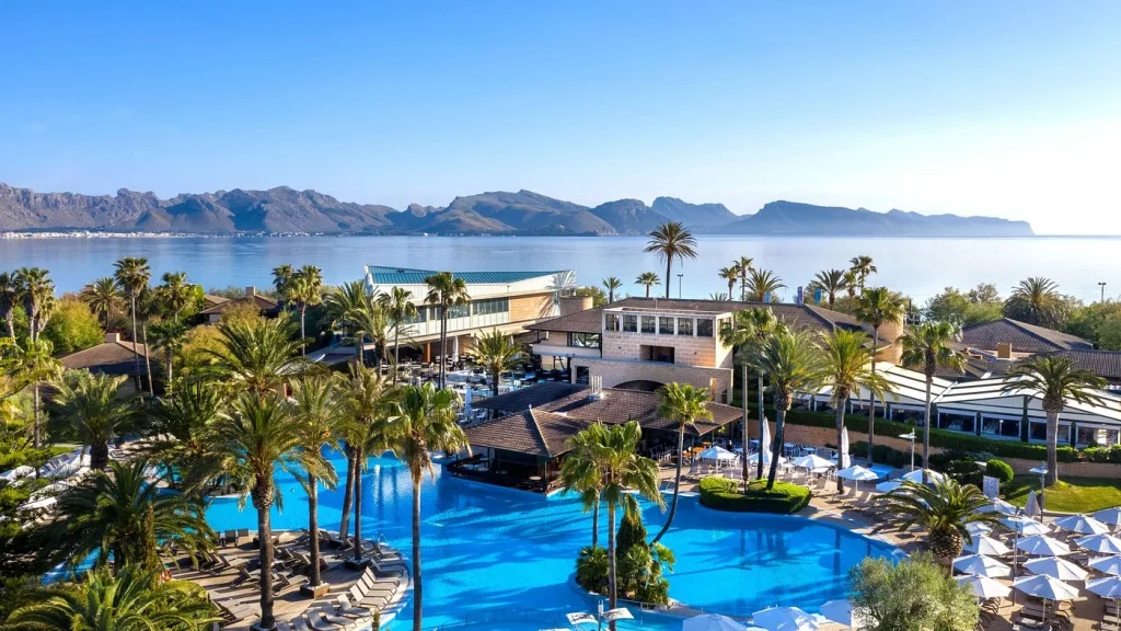 Lagoon-style pool and bay mountain views at PortBlue Club Pollentia Resort & Spa in Pollensa Bay, Mallorca.