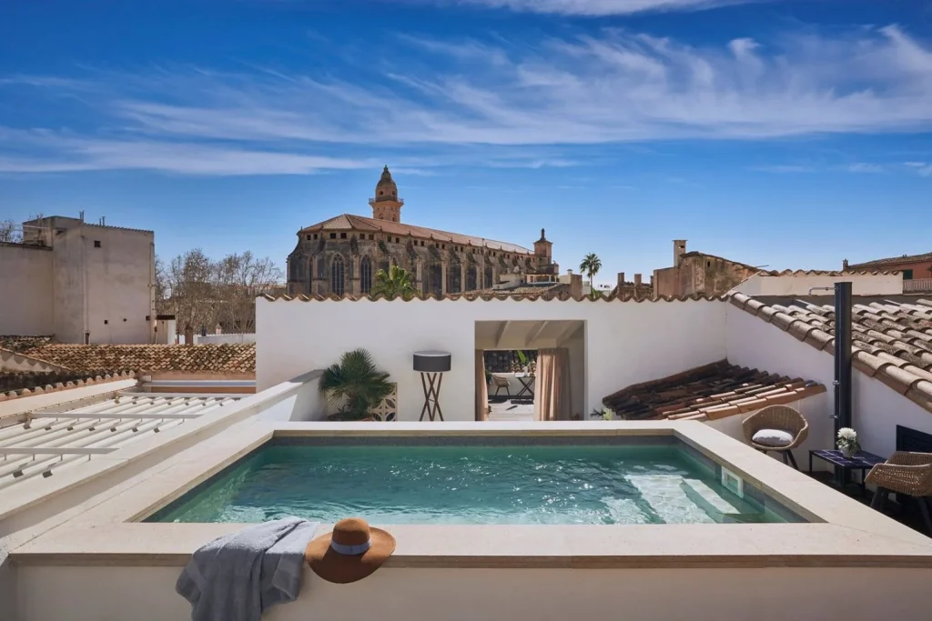 Rooftop plunge pool with views of Palma Cathedral and the historic city center at Posada Terra Santa in Palma, Mallorca