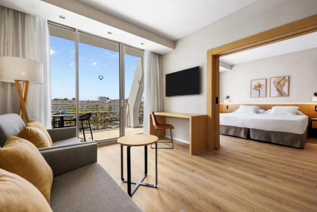 Suite with a separate living area and private balcony at Protur Sa Coma Playa Hotel & Spa in Sa Coma, Mallorca.