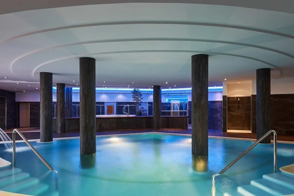 Indoor thermal pool with hydrotherapy features and ambient lighting at O Spa by Pure Salt Luxury Hotels in Mallorca.