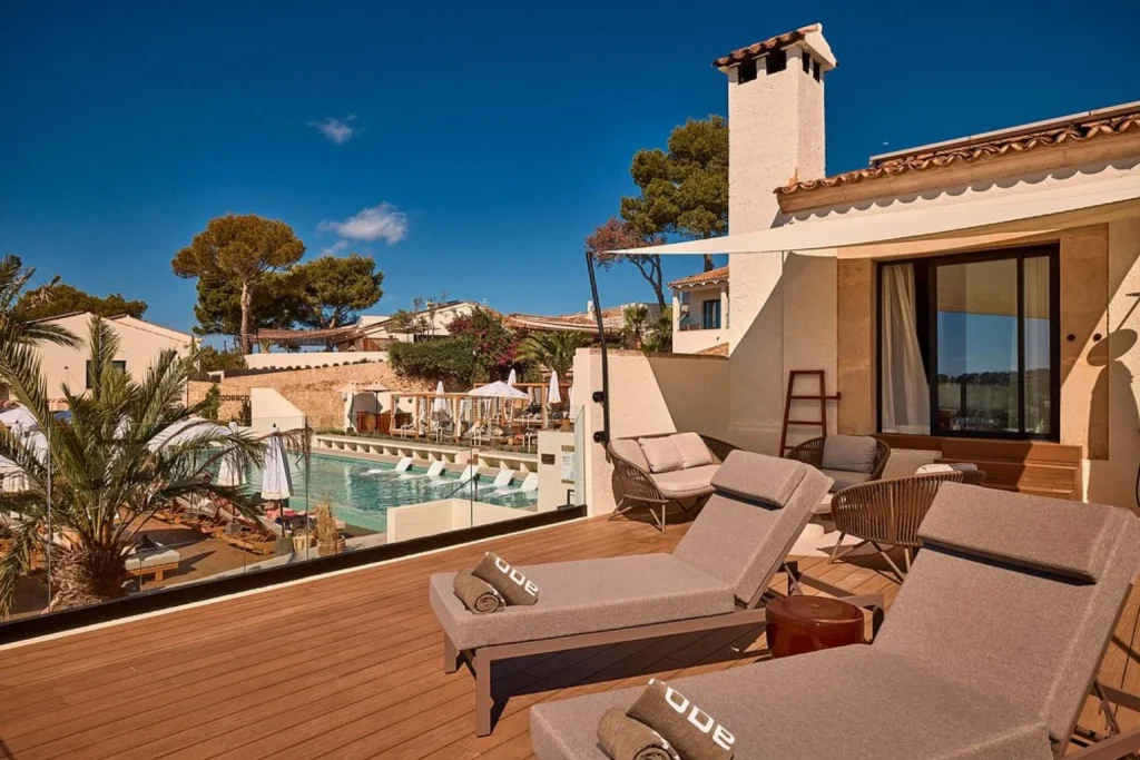 Private terrace suite with sun loungers, outdoor seating, and pool views at Purobeach Resort Santa Ponsa in Mallorca, Spain.