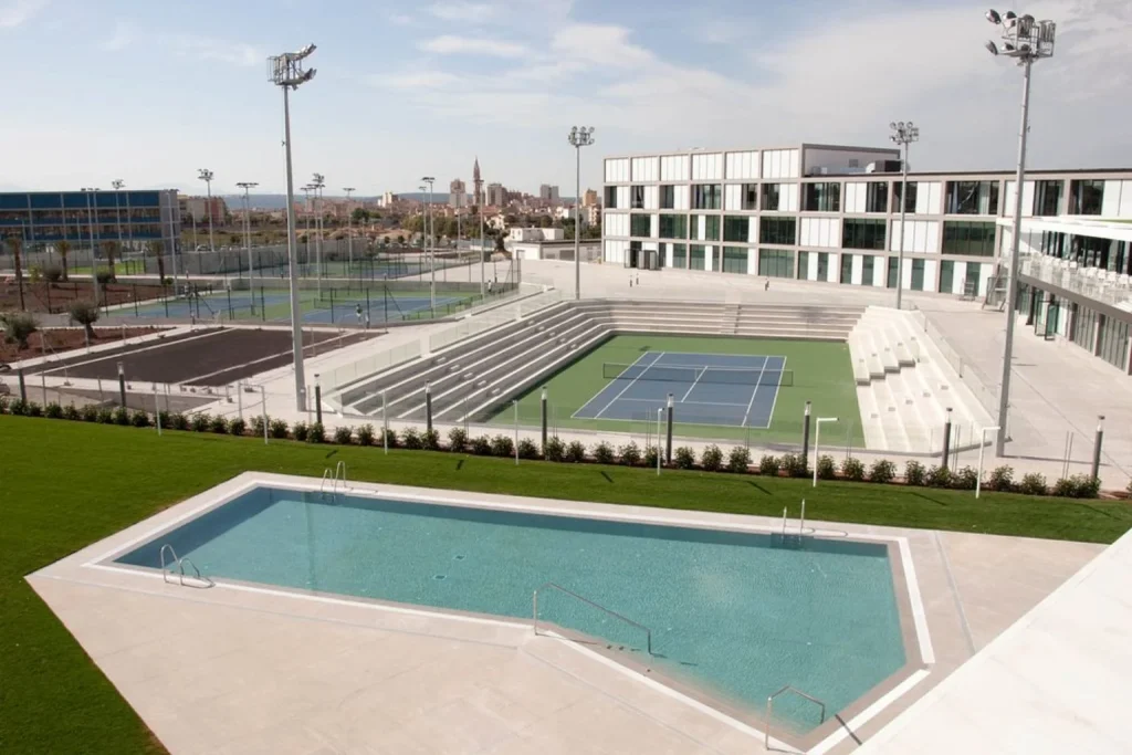 Outdoor swimming pool and tennis courts at Rafa Nadal Sports Centre (Rafa Nadal Residence) in Manacor.