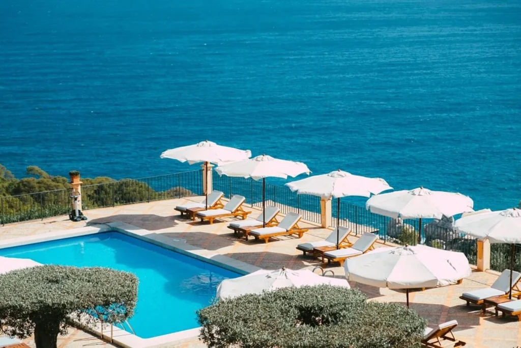 Seaview pool with sun loungers overlooking the Mediterranean Sea at Sa Pedrissa – Adults Only in Deià, Mallorca.