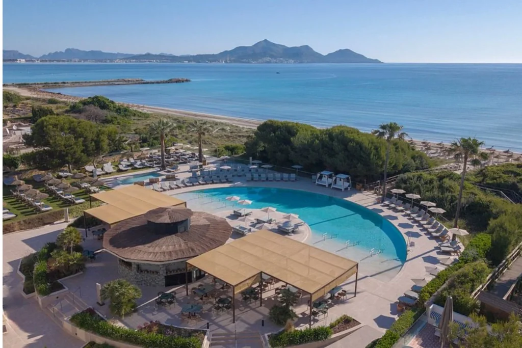 Lagoon-style swimming pool with beach view at Sarena de Muro Resort Mallorca in Playa de Muro, Mallorca