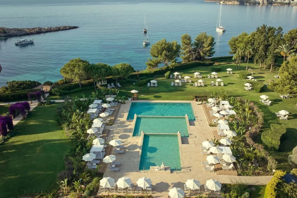 Oceanfront swimming pools and Mediterranean gardens at The St. Regis Mardavall Mallorca Resort in Costa d'en Blanes, Majorca.