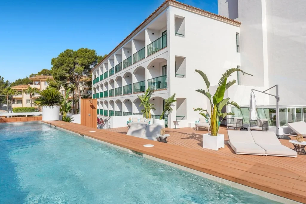 Modern outdoor swimming pool with sun deck at Valentin Somni Hotel & Suites in Peguera, Majorca.