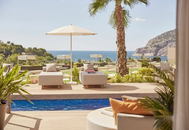 Poolside cabanas with Mediterranean sea views at Zafiro Palace Andratx in Camp de Mar, Majorca.